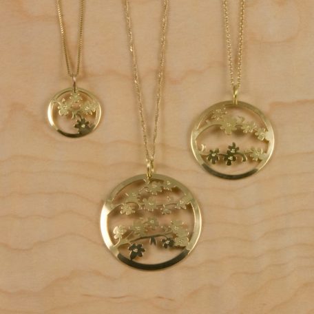 Three gold-plated necklaces adorned with Sendai Blossom Pendants.