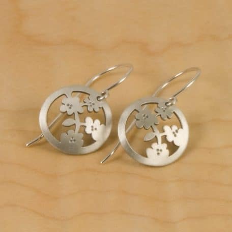 A pair of elegant Osaka Blossom Earrings adorned with delicate flowers.