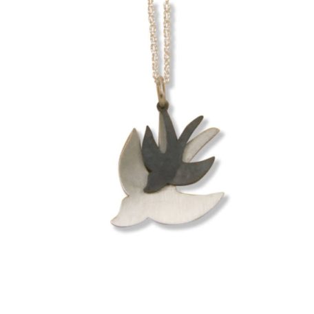 A Pendant featuring a bird in flight.