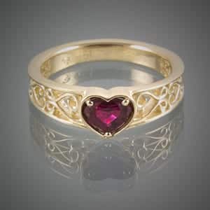 A gold ring with a heart-shaped ruby stone, straight from the heart.