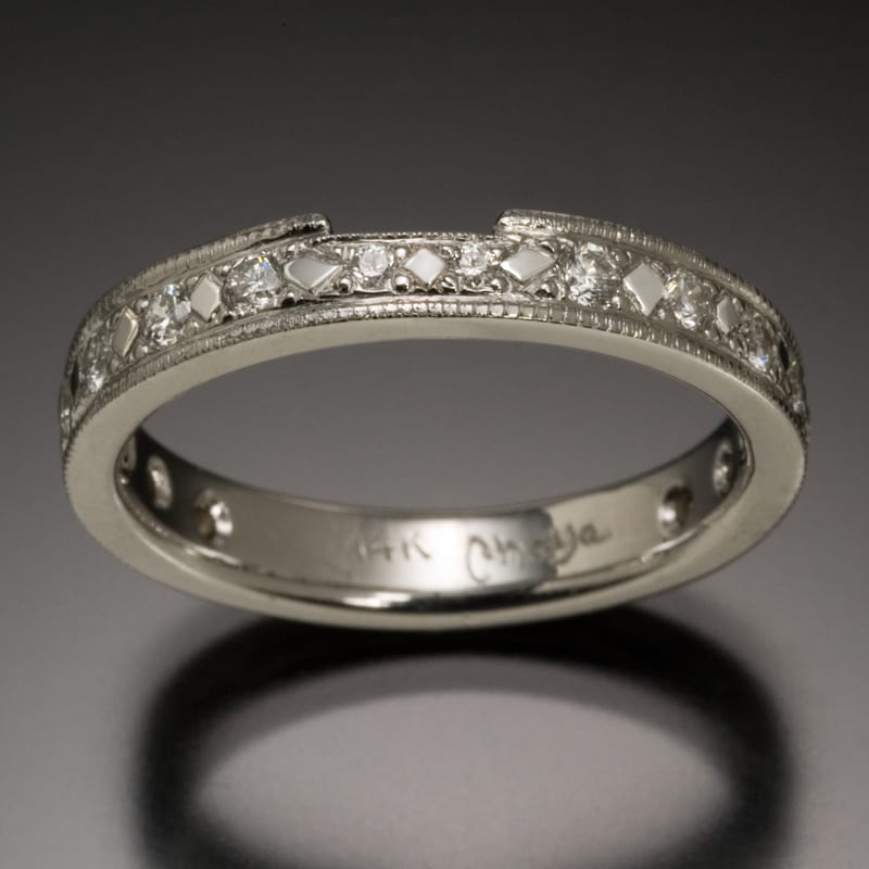 A custom white gold wedding band sparkling with diamonds.
