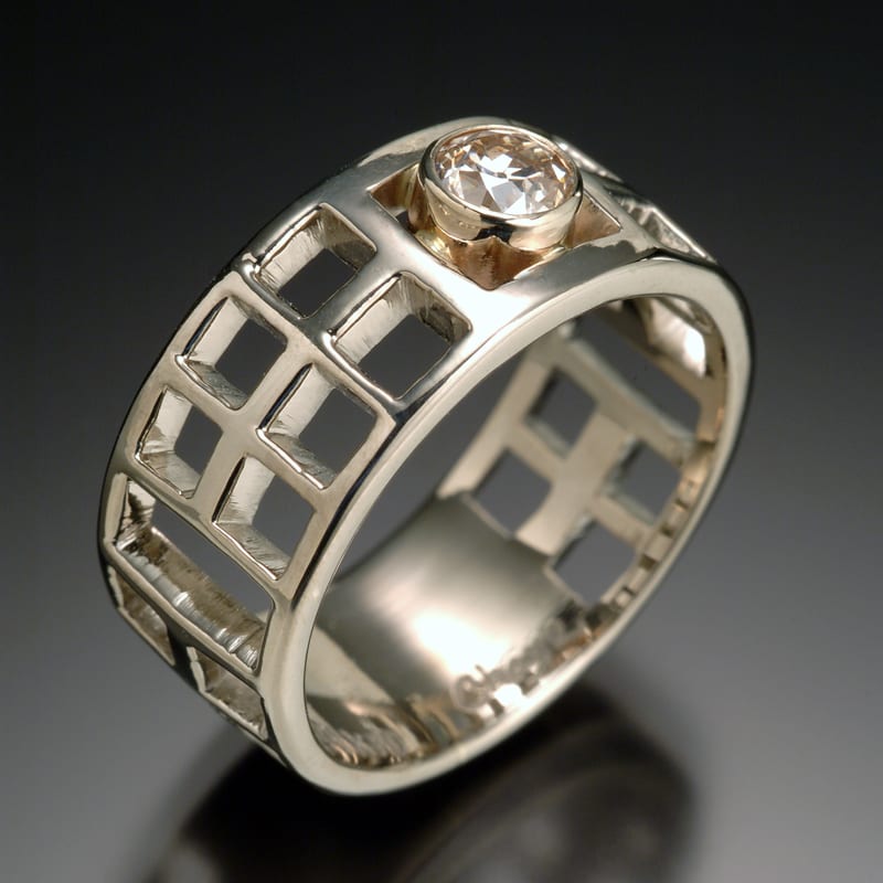A custom white gold ring with a diamond in the center.