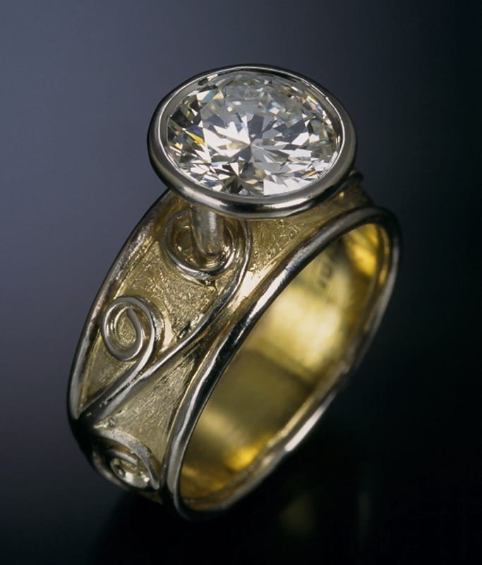 A custom gold ring with a diamond in the center.