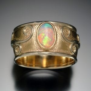 A custom gold ring adorned with a breathtaking opal stone.