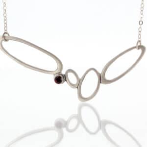A necklace with a garnet stone.