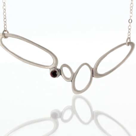 A necklace with a garnet stone.