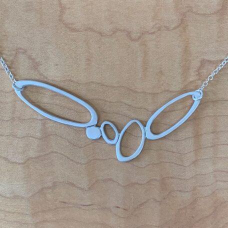 A necklace adorned with three circles on a long pond.