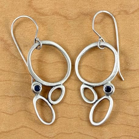 Sea Foam Earrings adorned with blue sapphire stones.