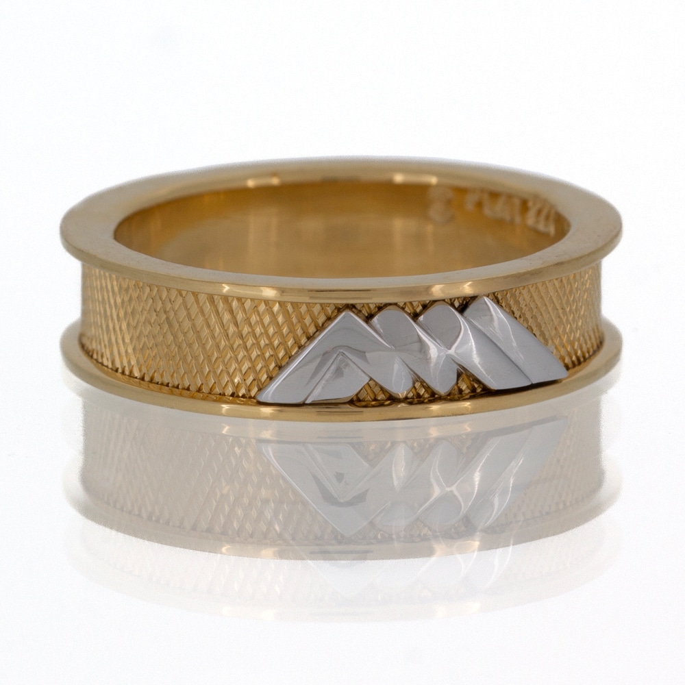 A custom gold ring with a mountain design.