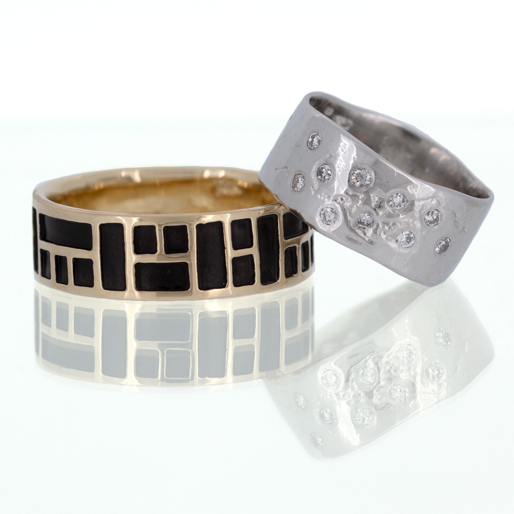 Two custom rings with black and white designs on them.