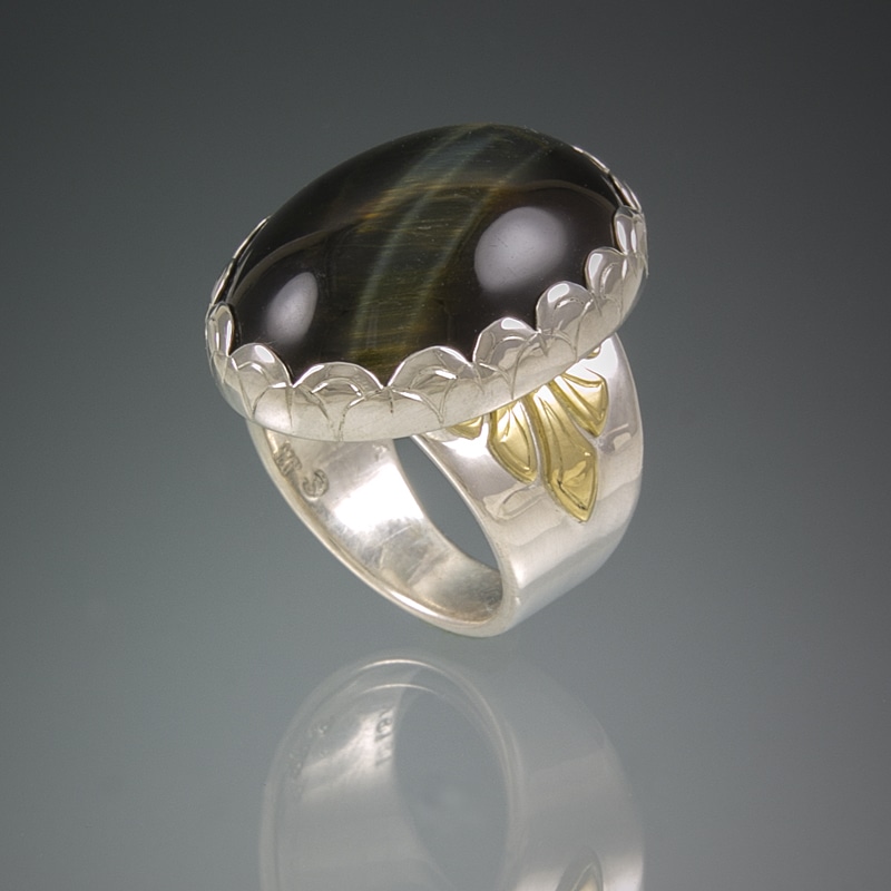A custom sterling silver ring with a tiger eye stone.