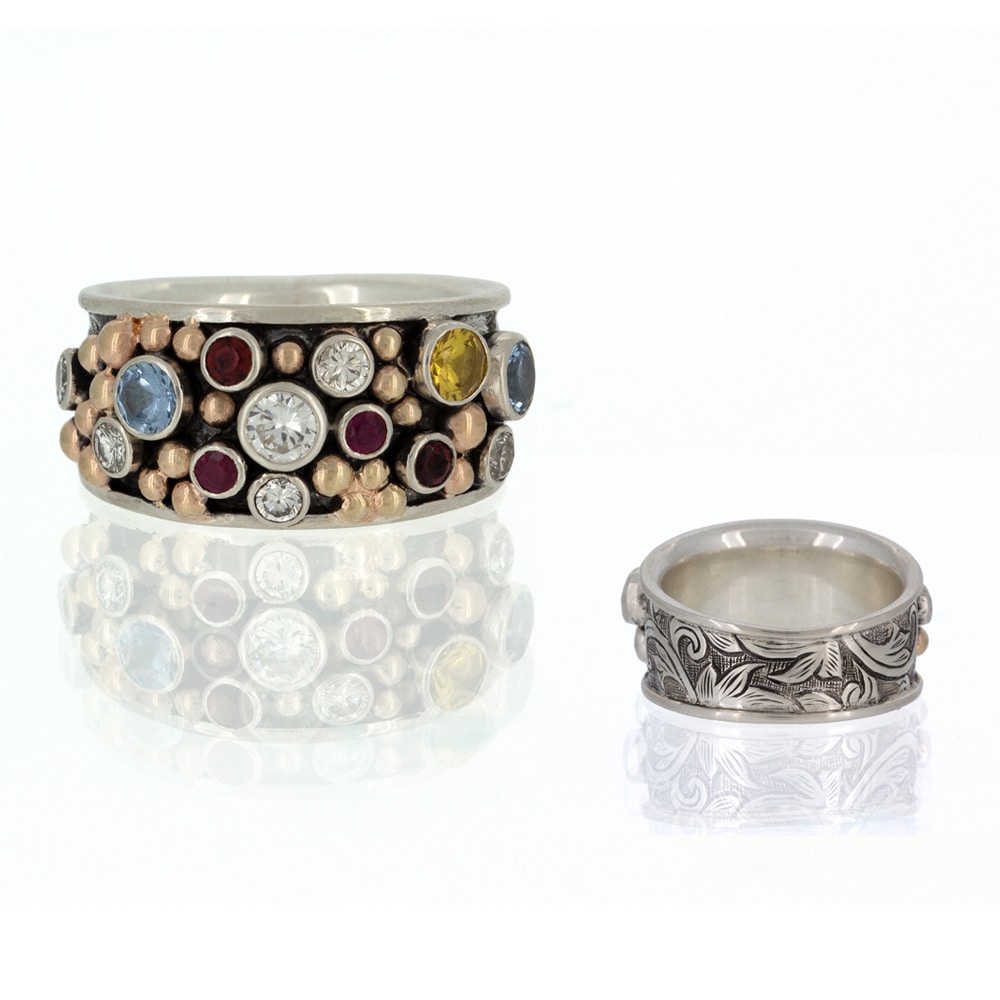 A custom silver ring adorned with multi-colored stones.