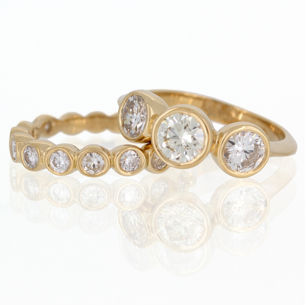A custom yellow gold ring set with three diamonds.