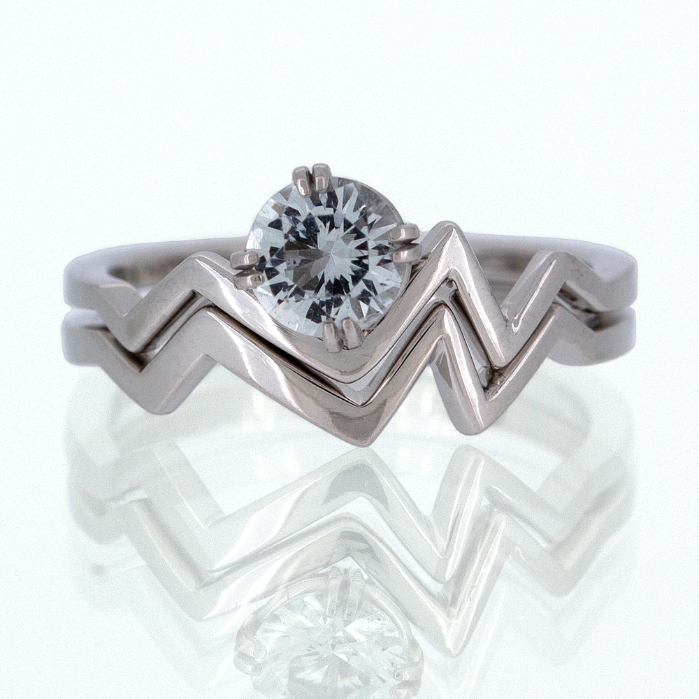 A custom white gold ring with a diamond in the middle.